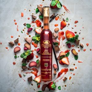 Pillitteri Estates Winery's 2016 Cabernet Franc Reserve Ice Wine beautifully displayed on a table top with strawberries, chocolate, rhubarb, mint and ice wine drizzles.